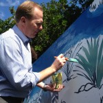 San Diego City Councilmember Kevin Faulconer helps paint the Rose Creek Mural.