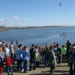 A crowd of onlookers gathers on the beach to watch the Rose Creek Duck Derby. Photo by San Diego EarthWorks.