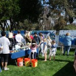 Volunteer painters line up to help paint the Rose Creek mural. Photo by San Diego EarthWorks.