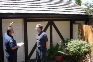 University City resident Bob Bayer and Deputy Fire Marshal Eddie Villavicencio discuss fire prevention at Bayer’s canyon-rim home. Bayer replaced his wood shake roof with fire-safe tiles to help protect his home from fire. Photo: San Diego Earthworks